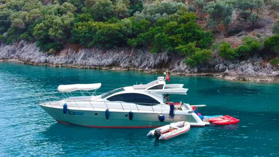 Motor yacht Germanor anchored in a scenic cove.