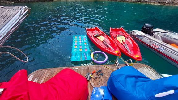 Water toys at the rear of motor yacht Germanor, canoes and inflatables ready for fun activities.