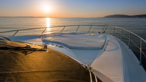 The deck of the Glorious motor yacht presents a serene view at sunset.