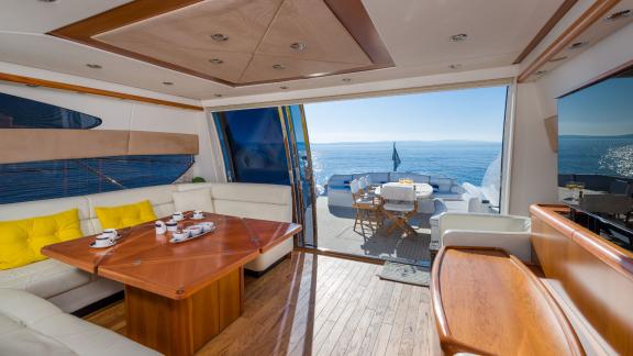 The interior of the Glorious motor yacht blending with the view of the exterior area.