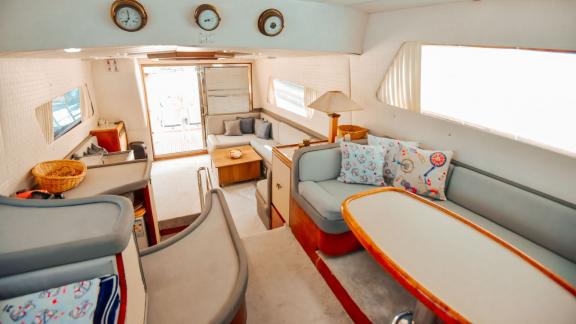 The interior saloon of Motoryacht Hayalim has a large seating area, dining table and comfortable armchairs.