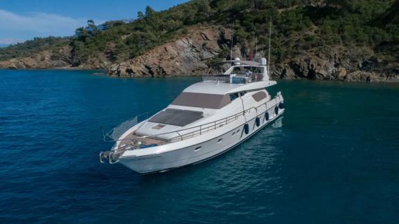 The Hurrem motor yacht is seen anchored in a green cove.