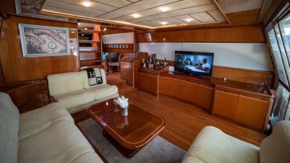 Comfortable seating area of the Hurrem motor yacht with a TV and interior decor offers a luxurious ambiance.