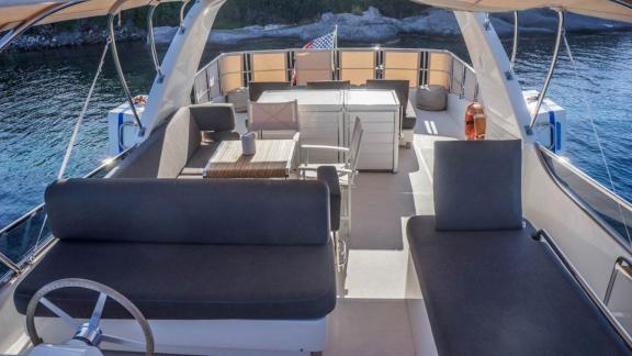 Spacious upper deck of Kuum motor yacht with relaxation areas.