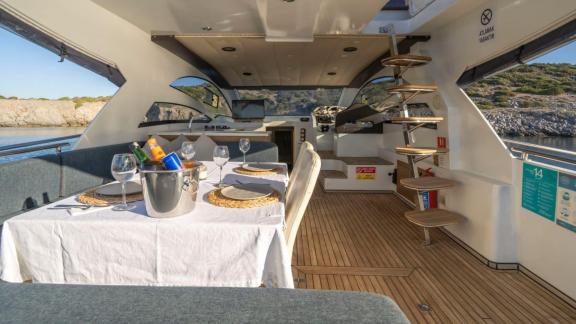 Interior of motor yacht Moonlight with a dining area and stairs.