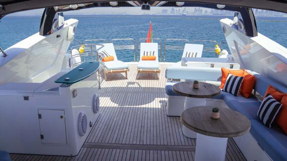 The open deck of the Notorious motor yacht offers a stylish and spacious setting for a yacht rental experience in Dubai.