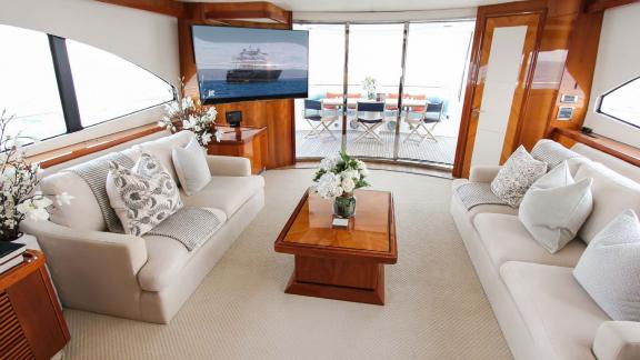 The elegant living area of the Notorious motor yacht enhances your Dubai yacht rental experience with luxury and comfort