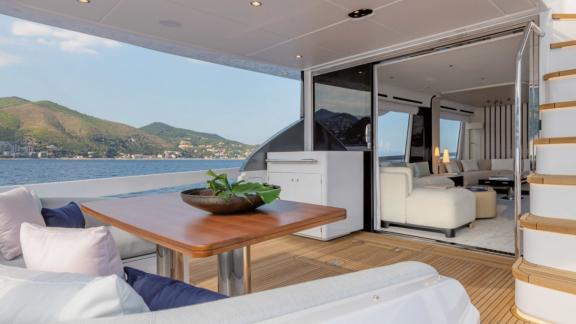 Modern living area with dining space on the yacht, offering a stunning sea view.