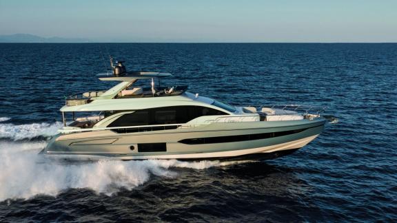 The motor yacht glides powerfully and elegantly over the open sea.