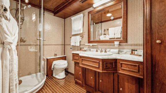 Großes Bad mit Marmortischplatte Holzmöbeln Dusche Waschbecken und WC. Luxusyacht Charter in Split.