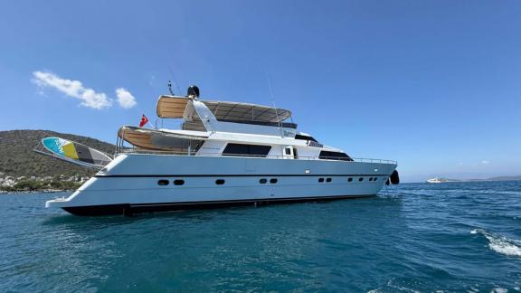 Sveti Sky motor yacht is anchored on turquoise waters with Bodrum hills in the background.