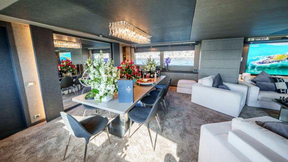 The modern dining room of Tatii 2 crowns the private yacht rental experience in Dubai.