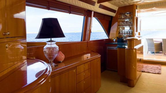 The interior of motor yacht Riva 21 features luxurious decor and large windows with sea views.