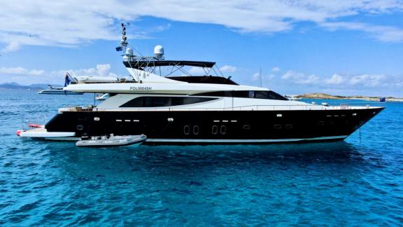 Motor yacht Usoa Bi stands out with its modern design and sleek lines over the turquoise sea.