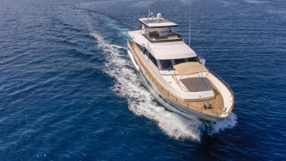 The motor yacht Vega cruising fast on the blue waters in Göcek, featuring an elegant and modern design.