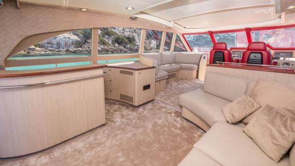 The salon of motor yacht Vintage offers a spacious seating area with a view of the bridge.