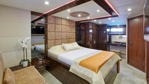 Luxurious master cabin of the motor yacht Wide Liberty with stylish decor and a spacious bed.