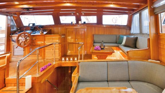 Explore the captain's area and cozy lounge of Gulet Myra with elegant wood paneling.