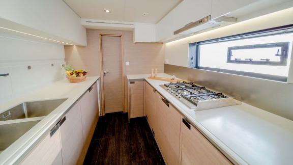 Well-equipped yacht kitchen with high-end appliances and side window