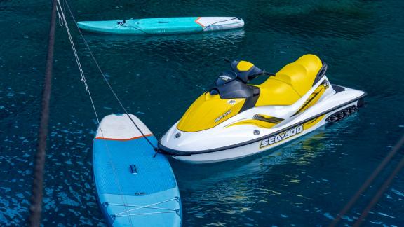 Jet ski and paddleboard on a motorised sailboat with 5 cabins in Fethiye, ready for adventure in the clear water.