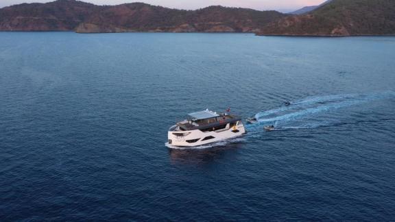 The luxury trawler Nayk 3 cruising in Göcek offers a pleasant sea journey with scenic nature views.