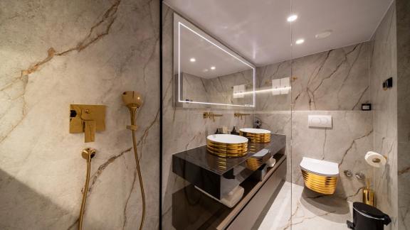 Elegant bathroom on Nocturno with gold fixtures and modern design.