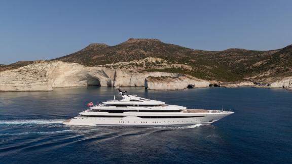 The modern luxury yacht Opari sailing past the picturesque cliffs of Greece.