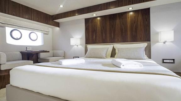 Spacious and well-lit bedroom on the Panta Rei motor yacht with modern design and cozy atmosphere.