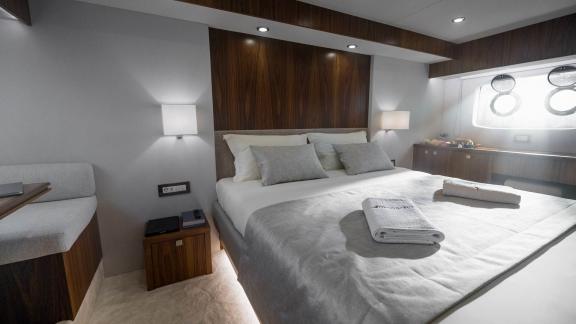 Elegant master bedroom on the Panta Rei motor yacht with king-size bed, modern amenities, and stylish decor.