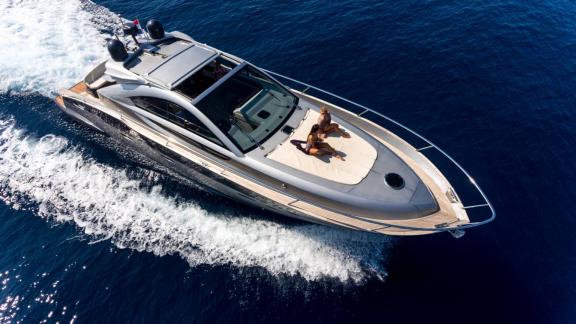 Cruising off Split, Silver Arrow features a foredeck sunbathing area for a luxury yacht charter experience.