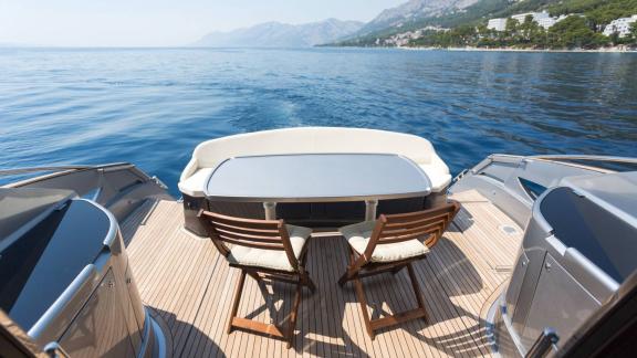 Silver Arrow in Split features an outdoor dining table and lounge area on the aft deck with sea views.