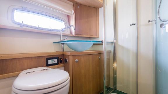 The bathroom of Silver Arrow in Split features a glass shower cabin, sink unit and practical onboard comfort.