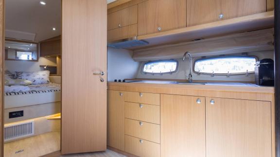 The interior of Silver Arrow in Split features a practical galley area connected to the guest cabin space.