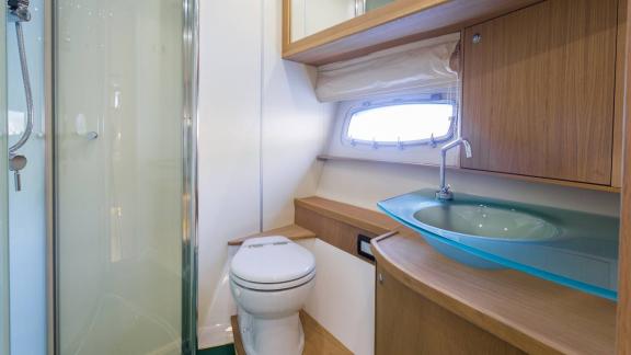 The bathroom of Silver Arrow in Split features a glass shower, sink unit and practical storage space.
