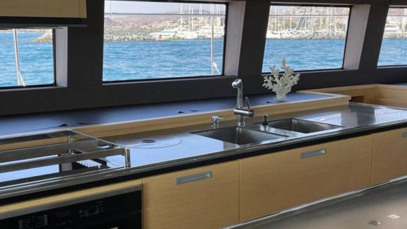 Stylish kitchen with elegant design and panoramic sea view aboard Lagoon 630 Pearly Gates in Lavrion.