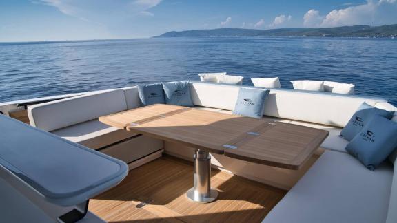 Among Saint Tropez yacht charter options Pegase motor yacht shows aft deck with table and comfortable seating.