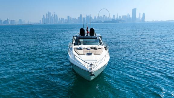 Pershing 5X White offers a perfect daily yacht charter experience with stunning views of Dubai.