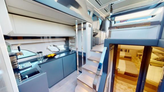 Pershing 5X White stands out with its sleek kitchen and modern interior design for luxury yacht rentals in Dubai.