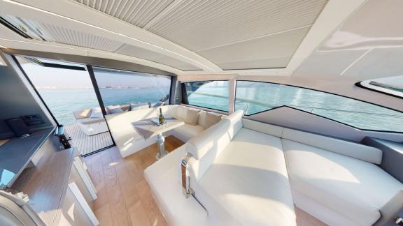 Pershing 5X White offers a spacious and elegant lounge for motor yacht charters in Dubai.