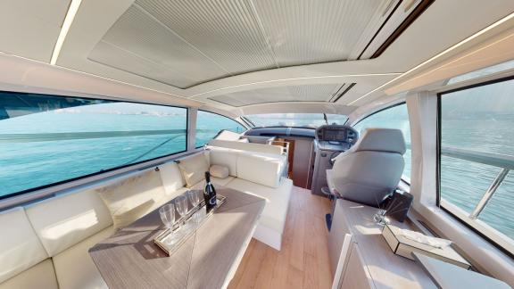 Pershing 5X White offers a modern helm station and spacious lounge for luxury yacht charters in Dubai.