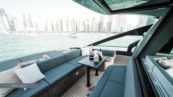 Discover the comfort of the modern main deck seating area of Pershing 5X Grey with Dubai yacht rental services.