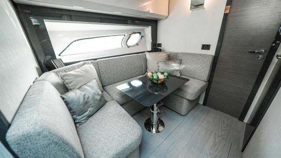 Enjoy the cozy seating lounge of Pershing 5X Grey with daily yacht rental in Dubai.