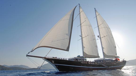 Experience the joy of sailing on a luxury yacht with full sails.