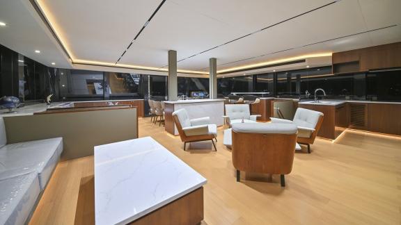 Evita power catamaran features lounge seating, a bar area and an open galley in the panoramic saloon.