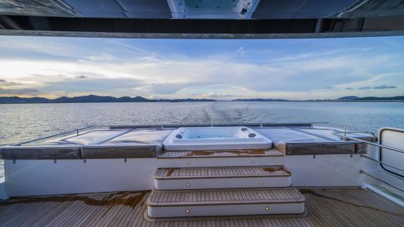 Evita power catamaran features a jacuzzi, sun pads and open sea views on the flybridge.