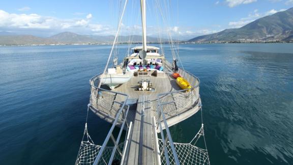 View from the front deck of the gulet Prenses Lila in Fethiye, with clear blue water and mountains in the background.