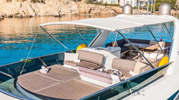 The flybridge of Blue M motor yacht in Mallorca includes lounge and sunbed areas.