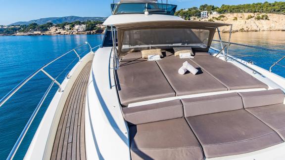 The foredeck of Blue M motor yacht in Mallorca features visible sunbeds.