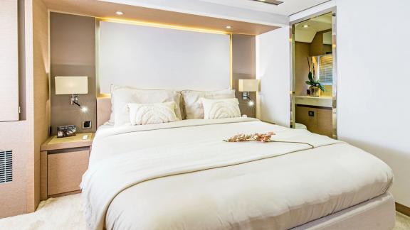 The double cabin of Blue M yacht in Mallorca features a large bed and private bathroom.