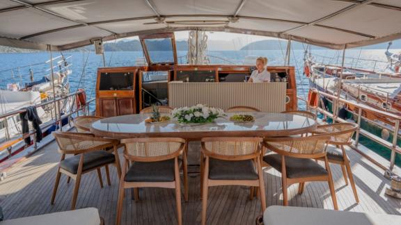 Princess Alize gulet features a spacious outdoor dining table and comfortable seating area on the aft deck.